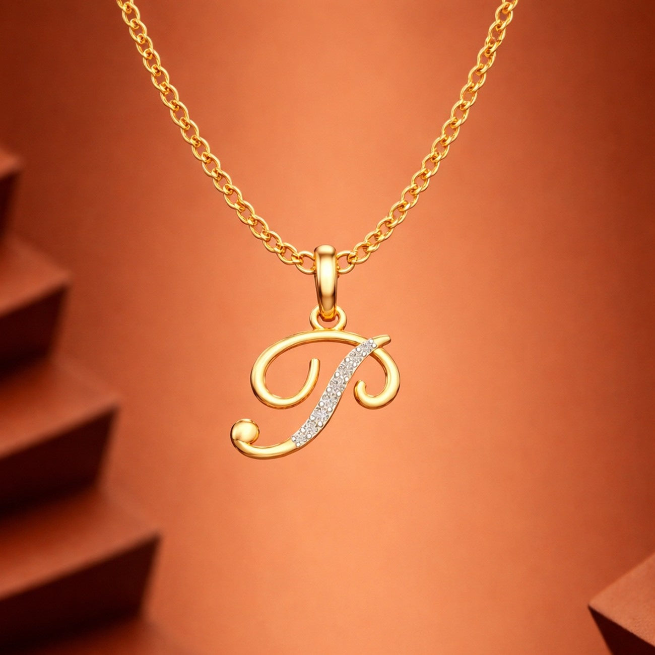 Gold necklace with a 'D' pendant on an orange background