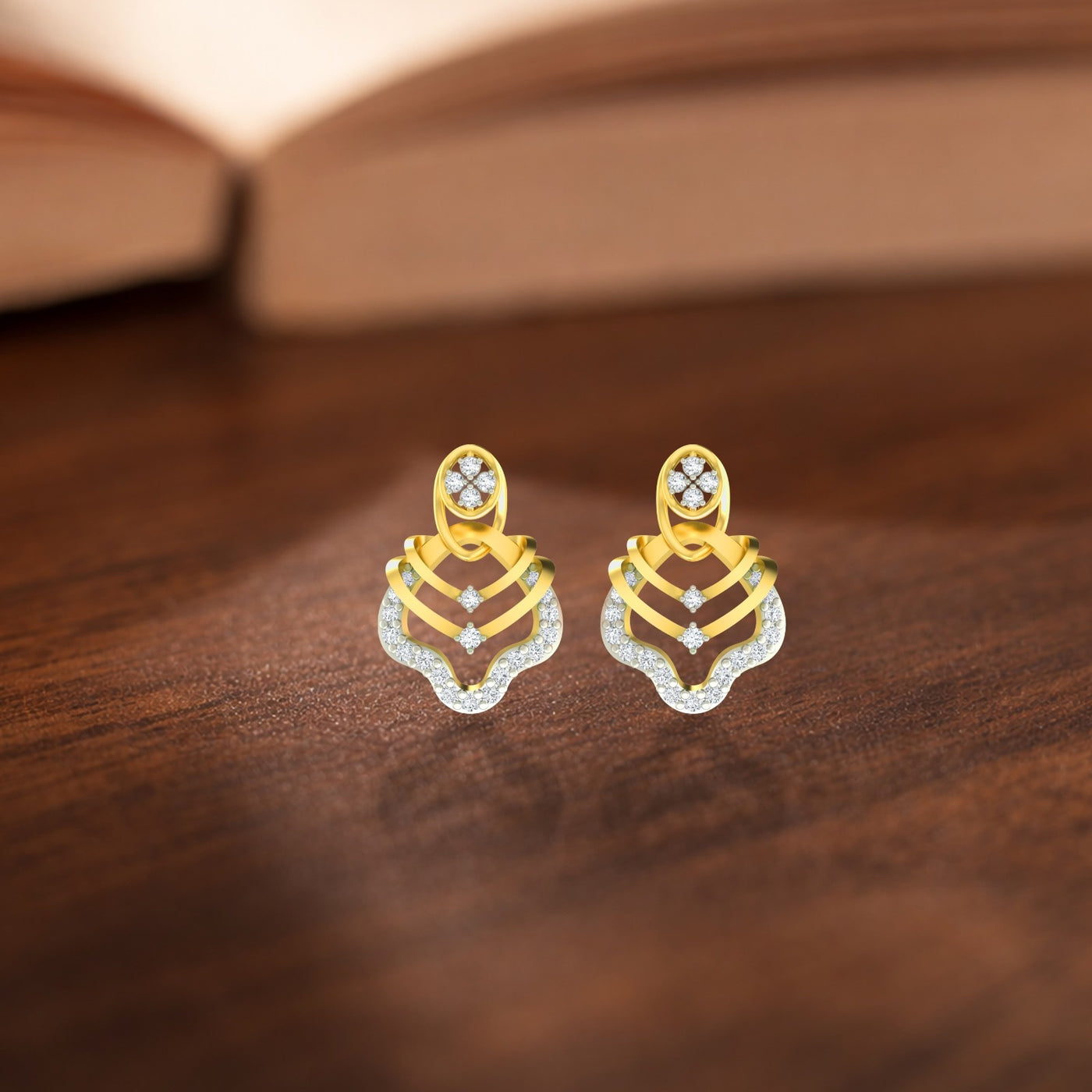 Pair of gold and diamond stud earrings on a wooden surface.