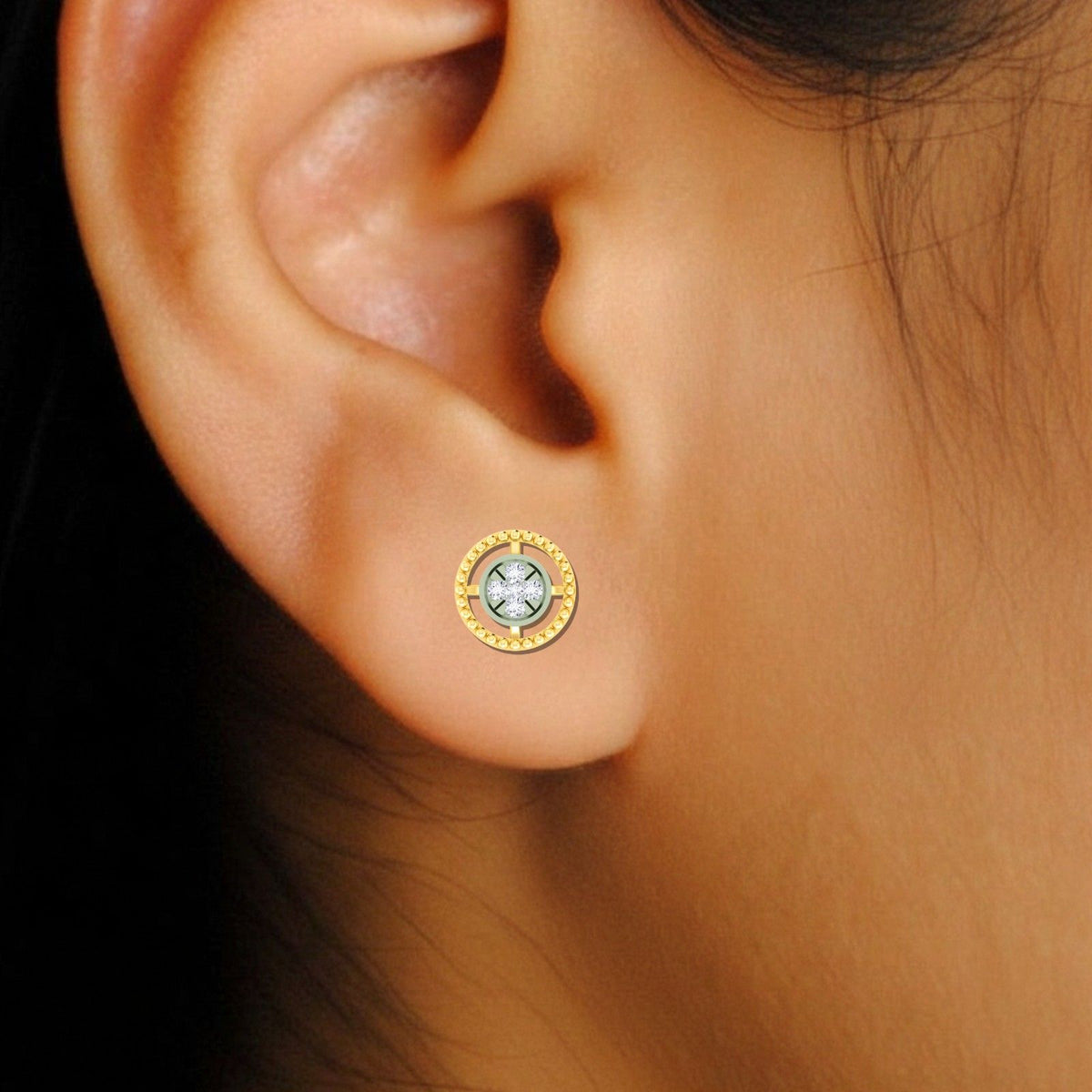Gold and diamond earring with a round-shaped on an ear