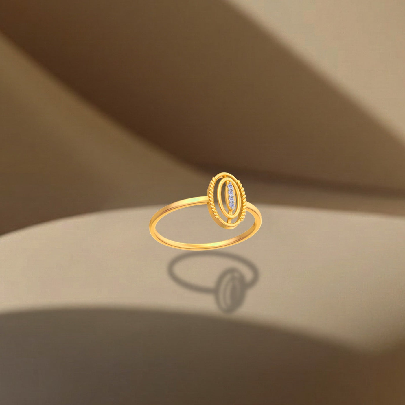 Gold ring with a central gemstone on a beige surface