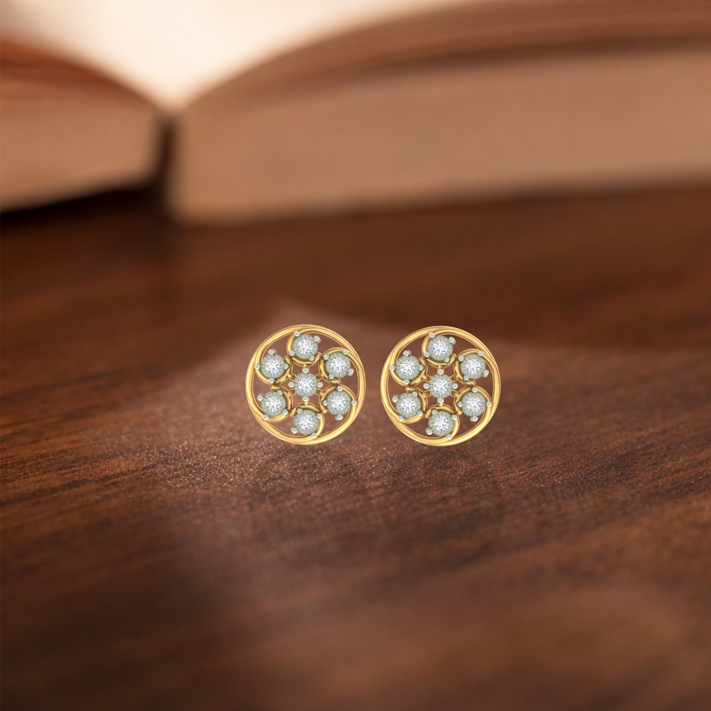 Gold and diamond stud earring with round-shaped on a wooden surface.