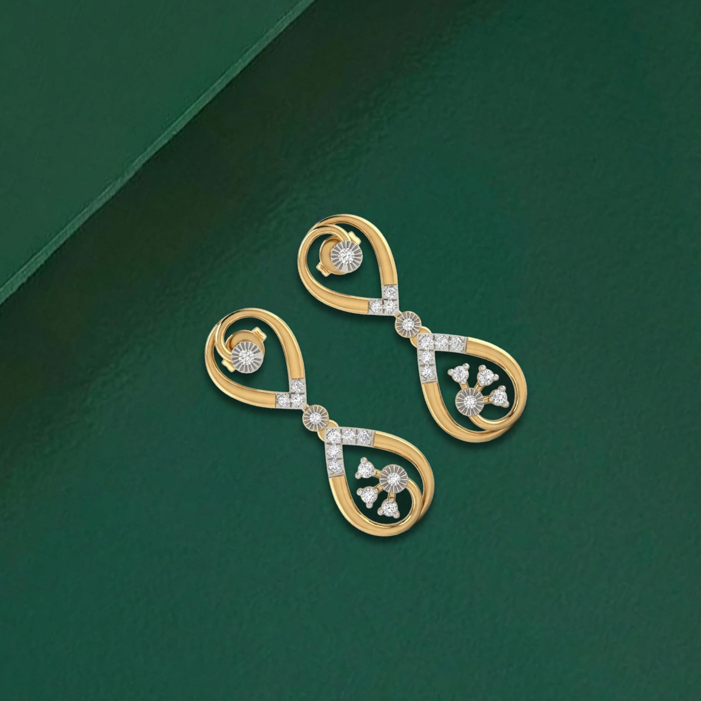 Gold and diamond drop earrings on a green background.