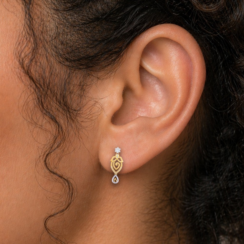 Close-up shot of a gold and diamond earrings with intricate designs.