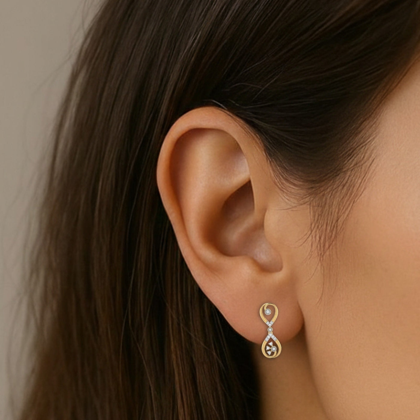Close-up shot of a gold and diamond drop earrings.