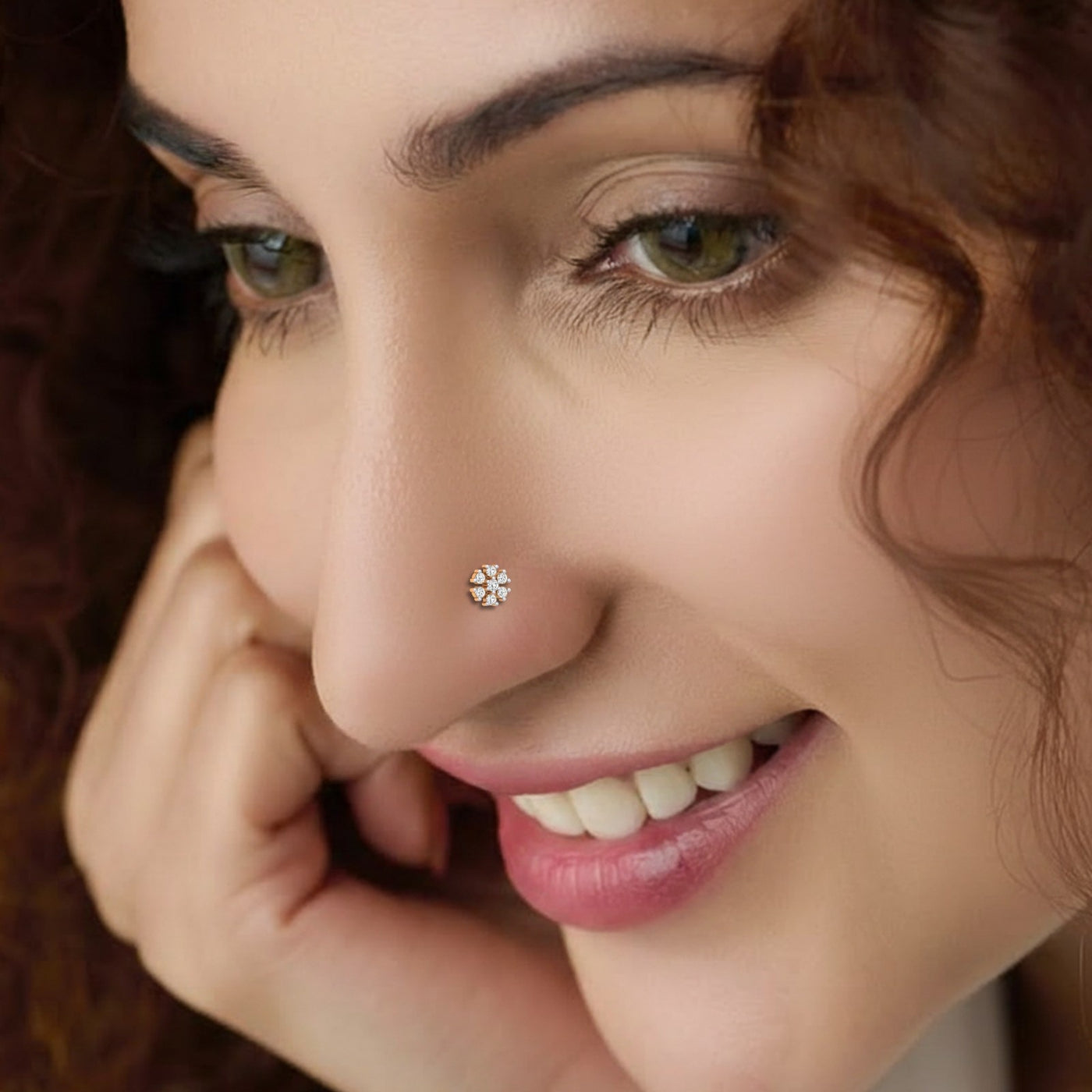 Close-up of a woman wearing a diamond nose pin with a blurred background