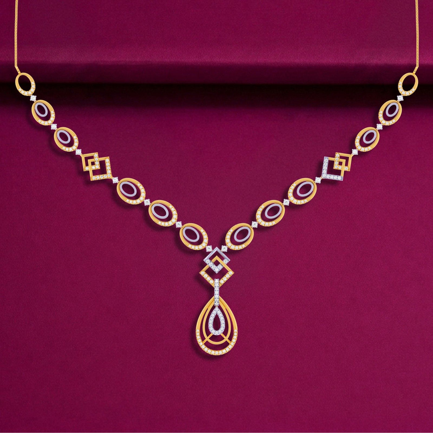 Gold necklace with a teardrop pendant on a purple background