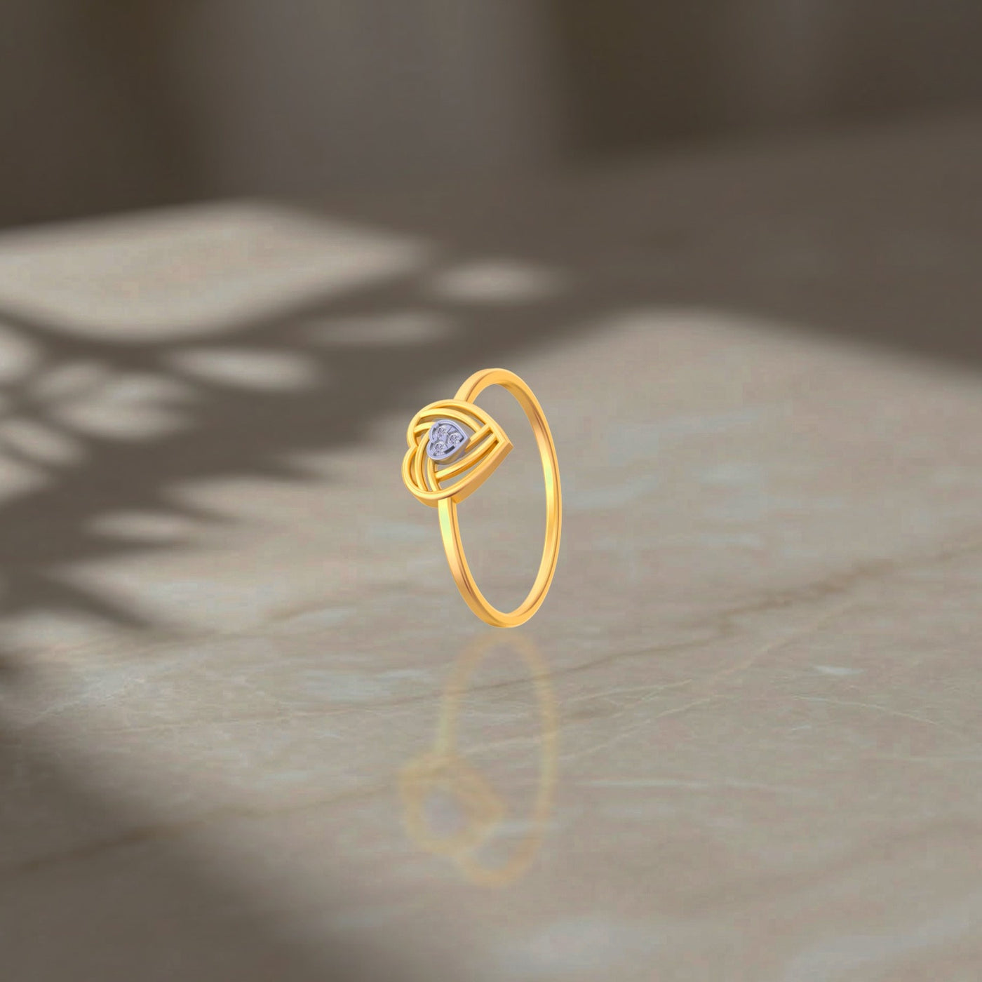 Gold ring with a purple gemstone on a marble surface