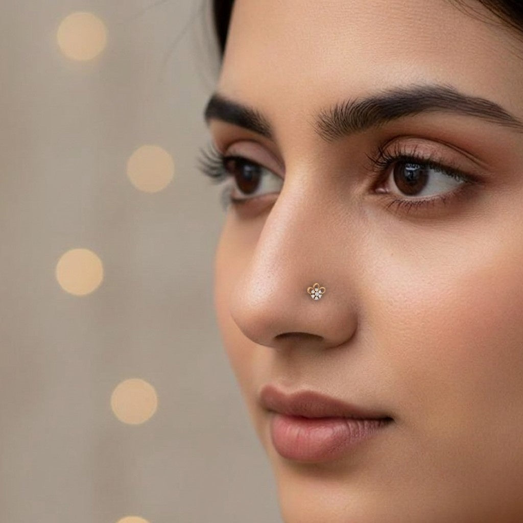 Close-up of a woman's face with a nose pin against a neutral background