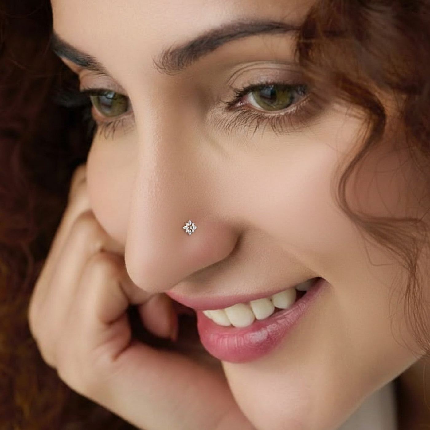 Close-up of a woman wearing a diamond nose pin with a blurred background