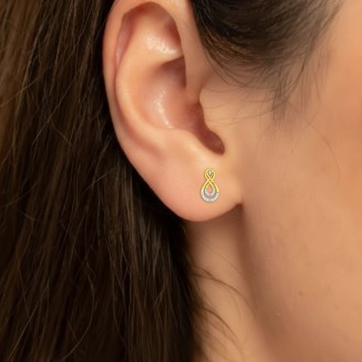 Close-up shot of a gold and diamond stud earrings.