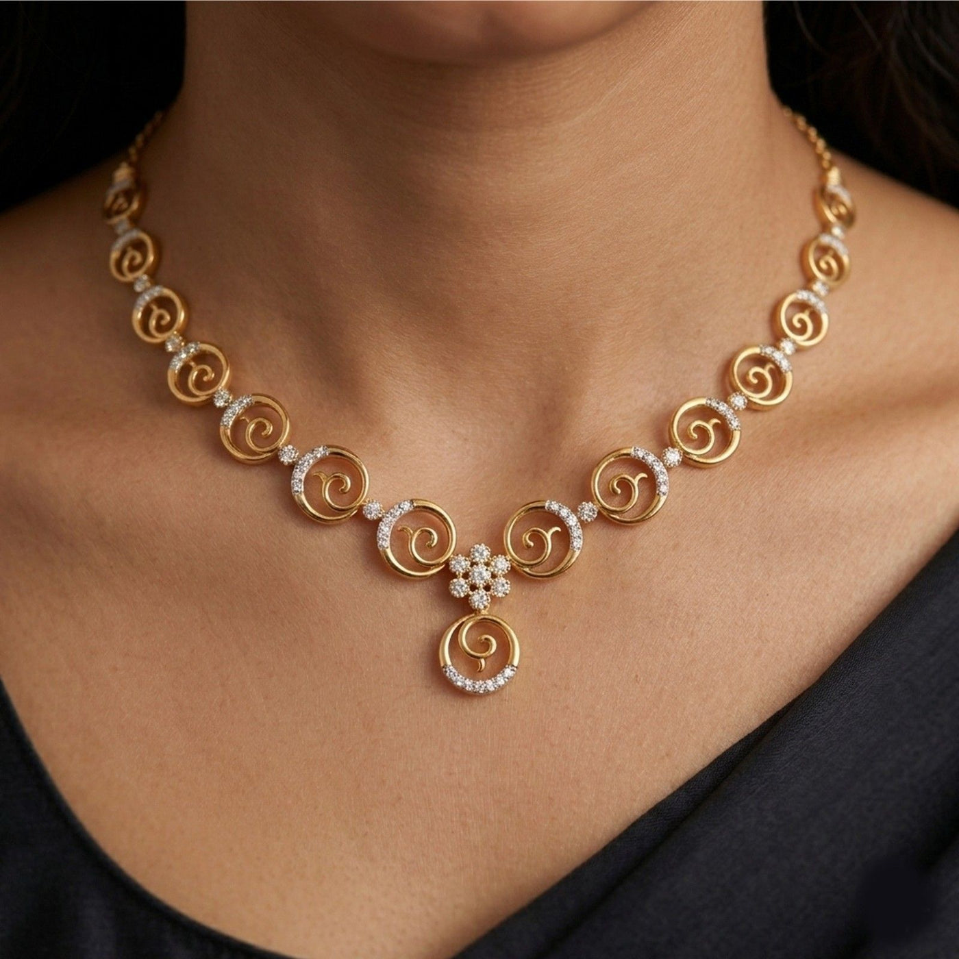 Gold necklace with circular design and diamond accents worn by a person.