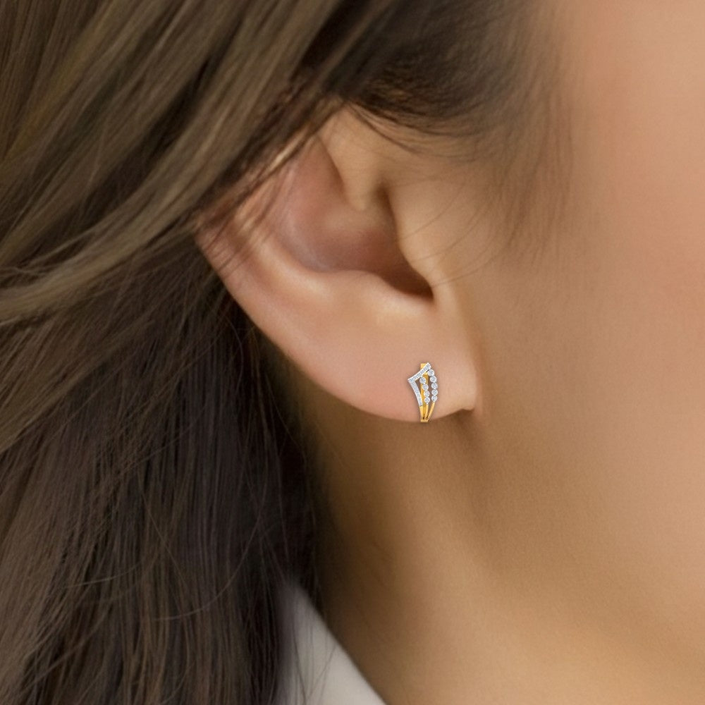 Close-up shot of a gold and diamond hoop earrings with diamond accents.