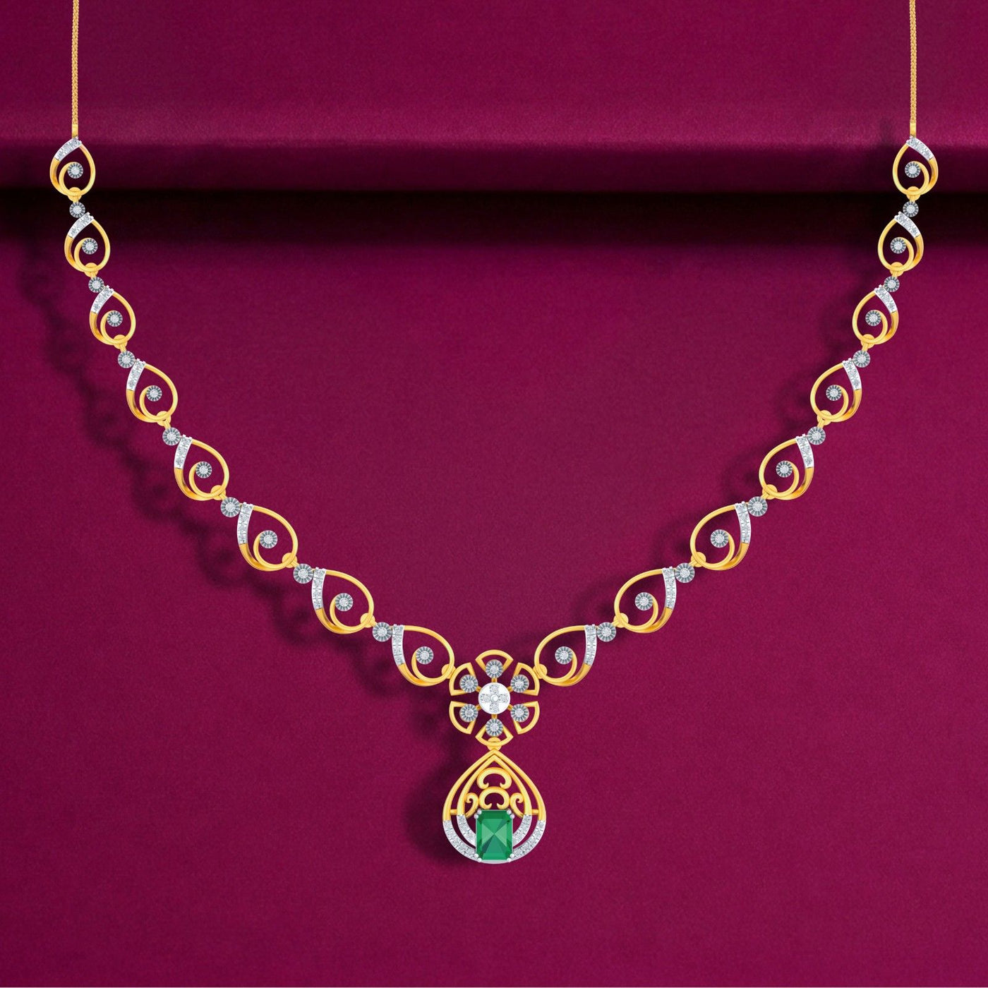 Gold and diamond necklace with a green emerald pendant, displayed on a deep magenta background.