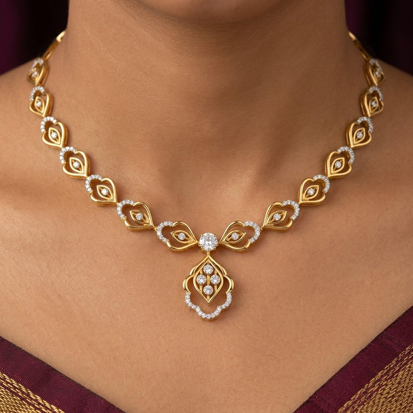 Gold and diamond necklace with diamond accents, shown worn on a model's neck.
