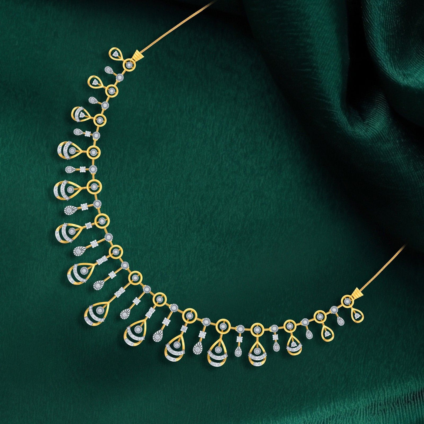 Gold and diamond necklace on a green fabric background