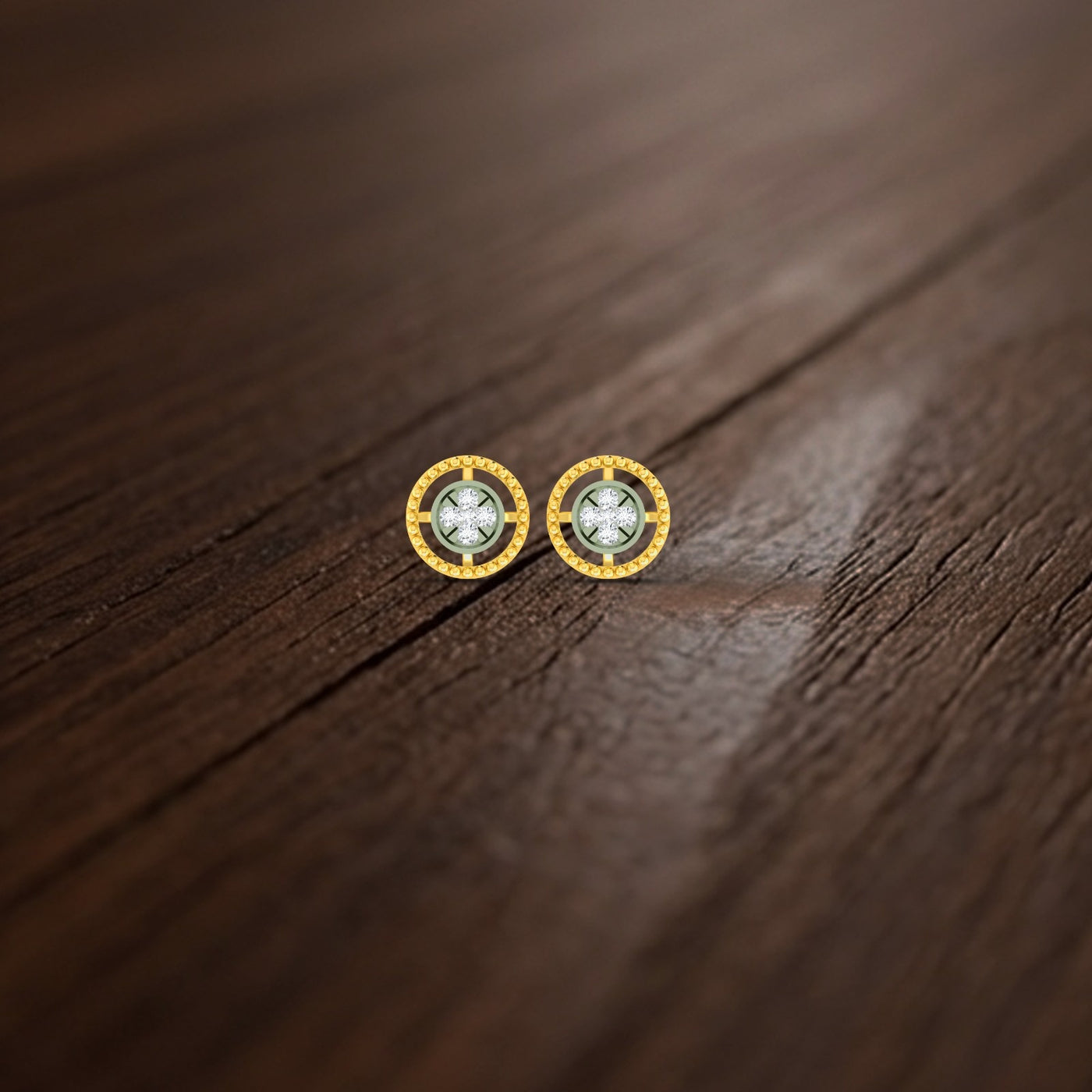 Gold and diamond round-shaped earrings on a wooden surface