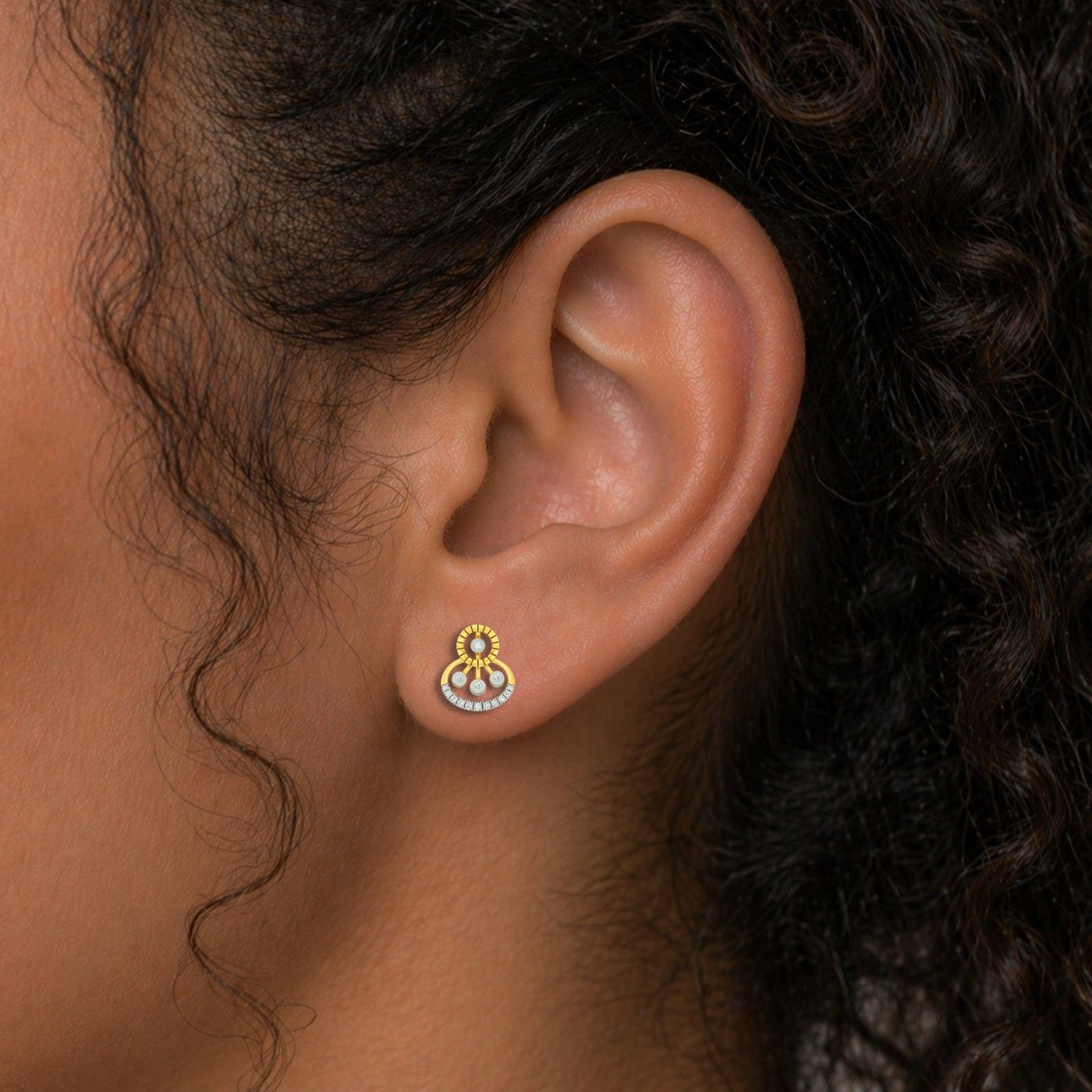 Close-up shot of a gold and diamond stud earrings.