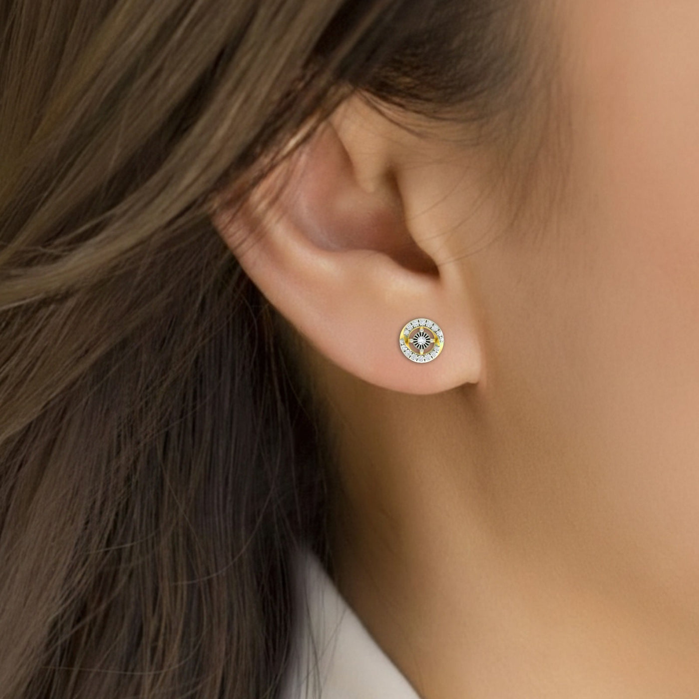 Close-up shot of a gold earrings with diamond accents earring.