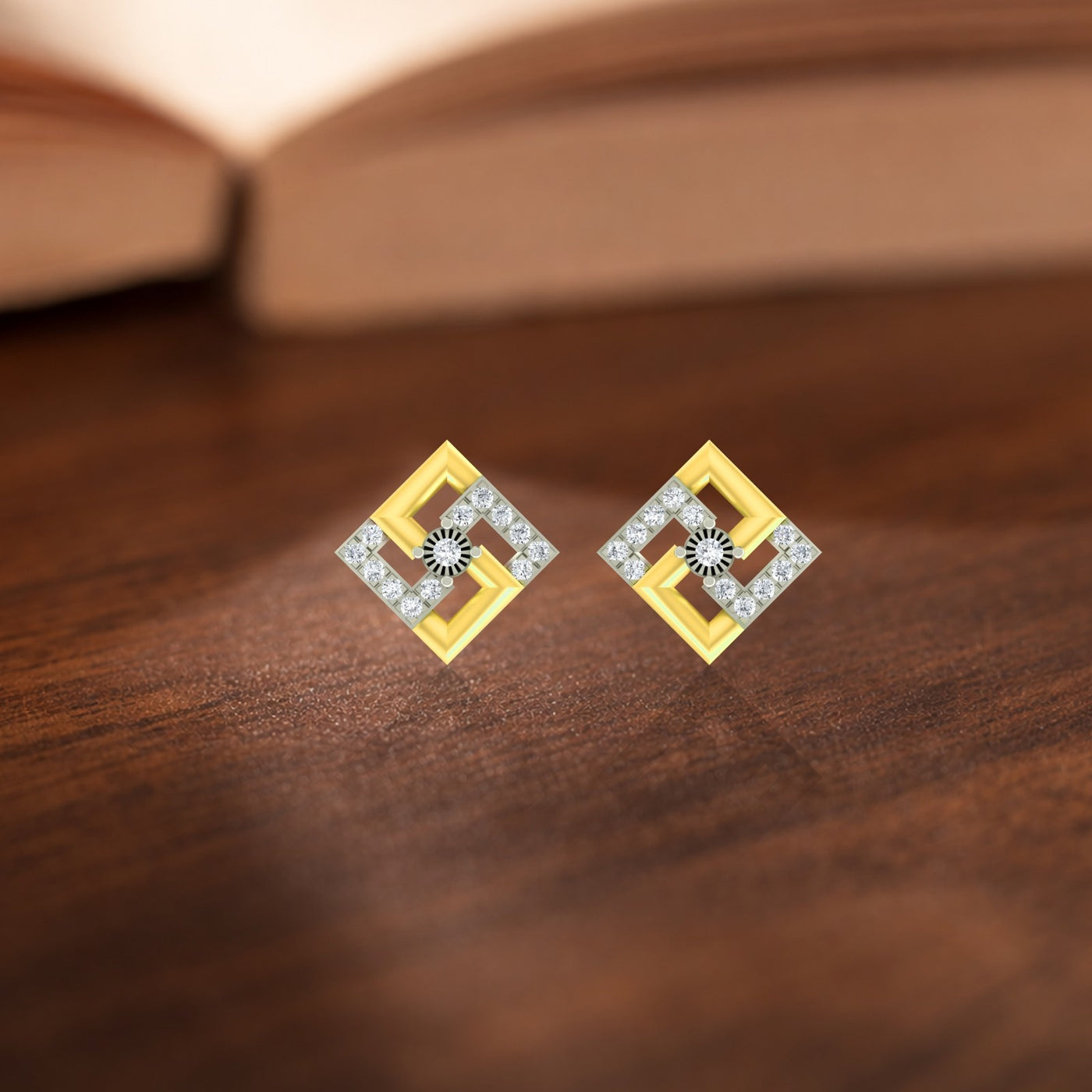 Gold square earrings with diamond accents on a wooden surface