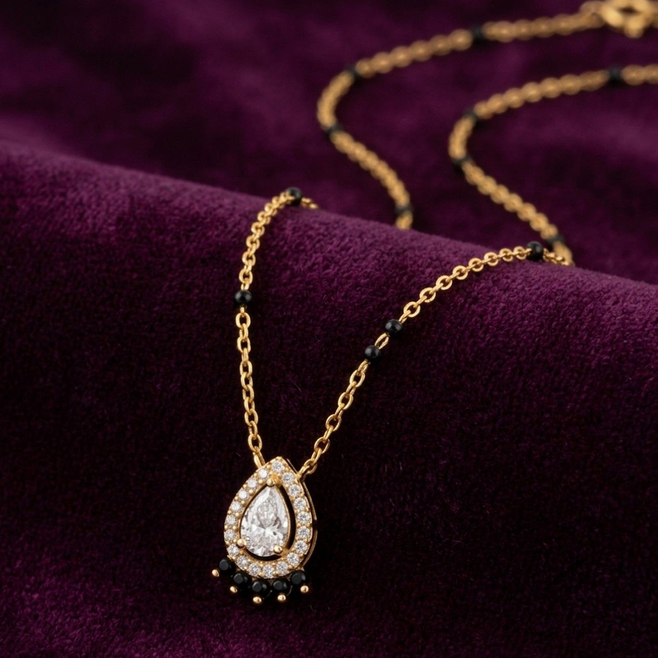 Yellow gold & diamond beaded mangalsutra on dark maroon background