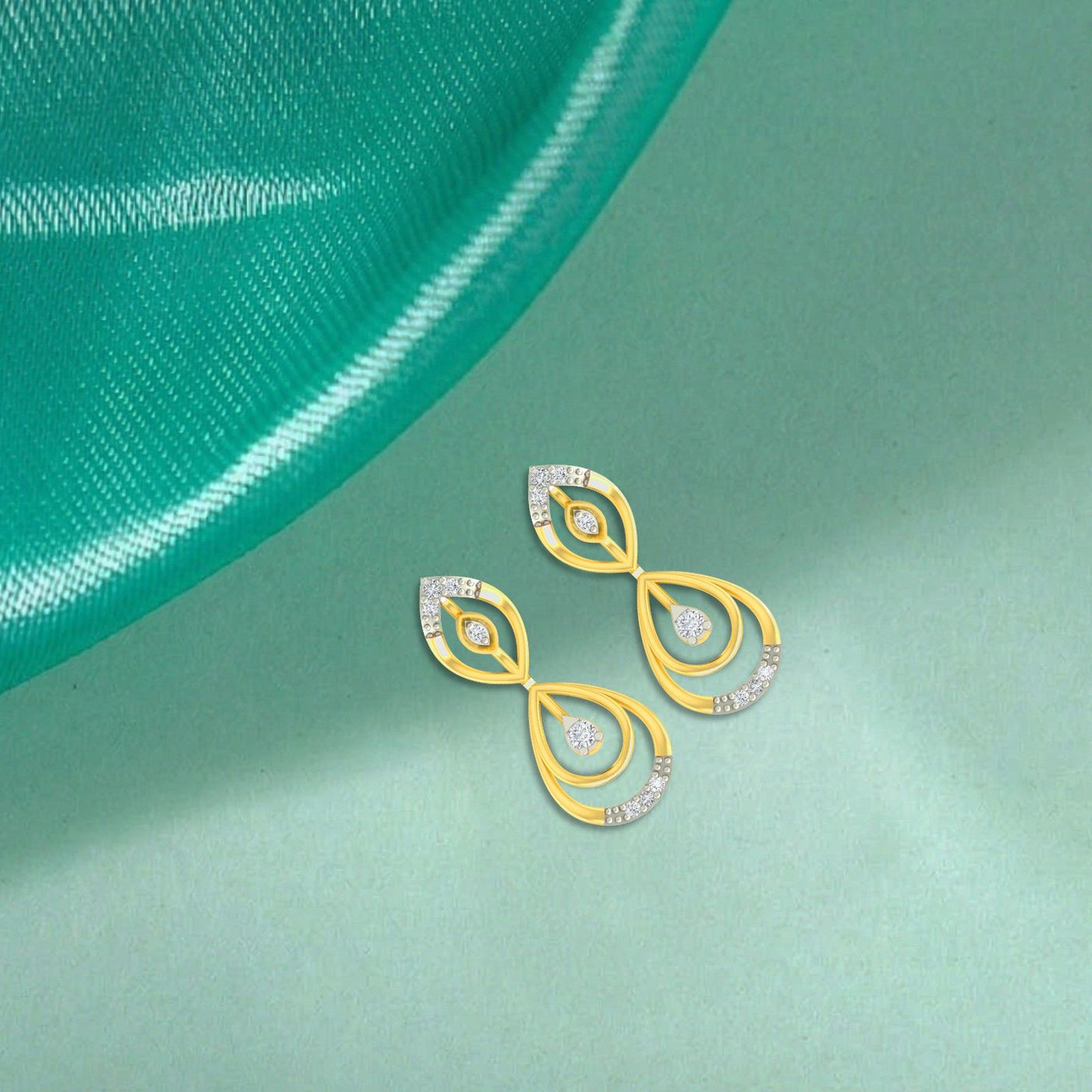Gold and diamond teardrop drop earrings on a  background.