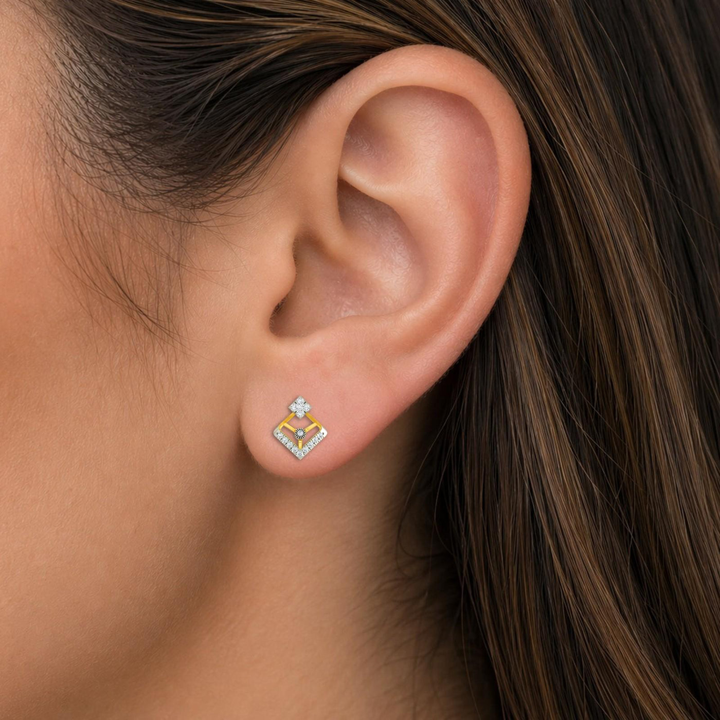 Close-up shot of a gold and diamond stud earrings.
