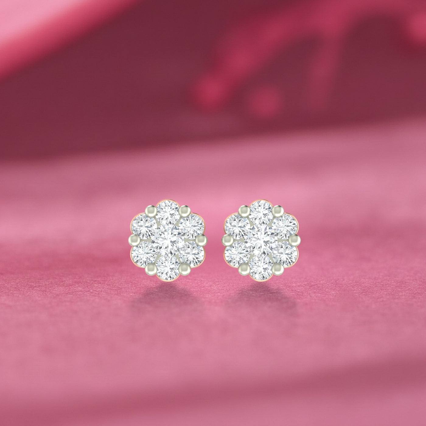 Gold and diamond stud earring with floral-design on a pink background.