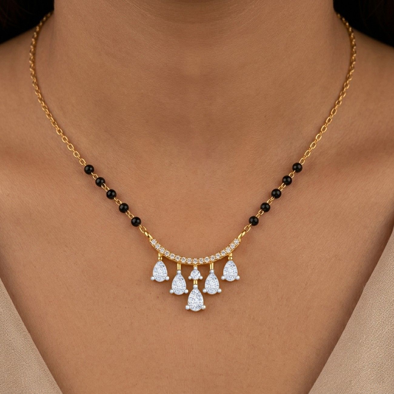 Women wearing classic gold & diamond beaded mangalsutra on grey top