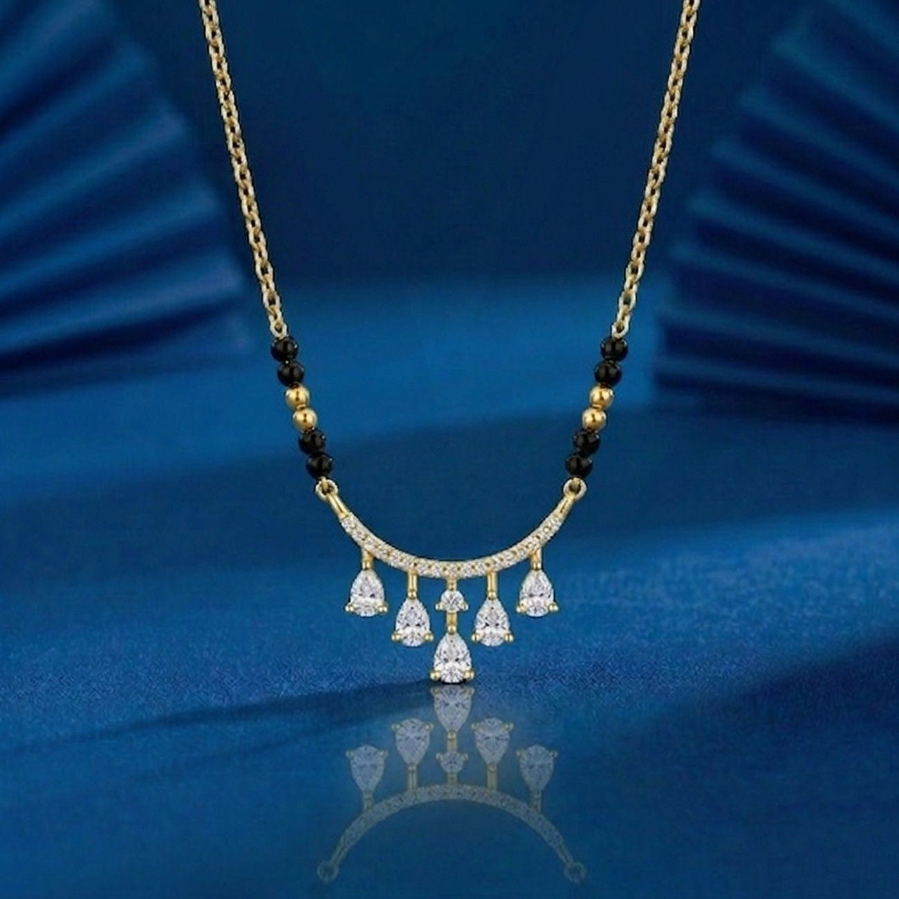  classic gold & diamond beaded mangalsutra on blue background