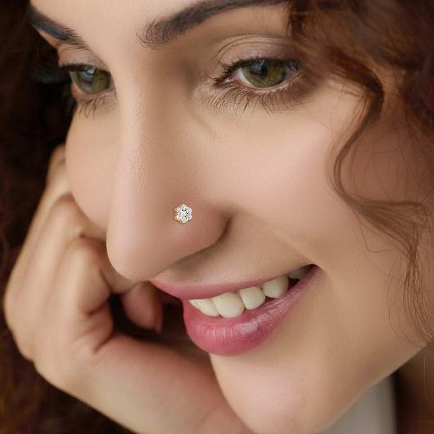 Close-up of a woman wearing a diamond nose pin with a blurred background
