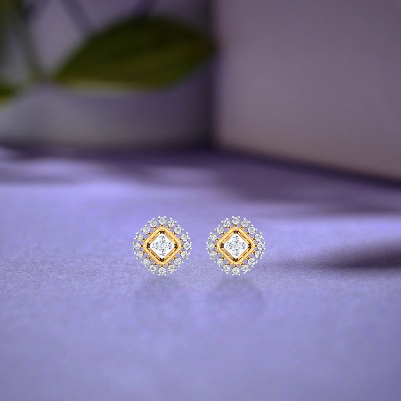 Gold and diamond stud earring on a blue surface.