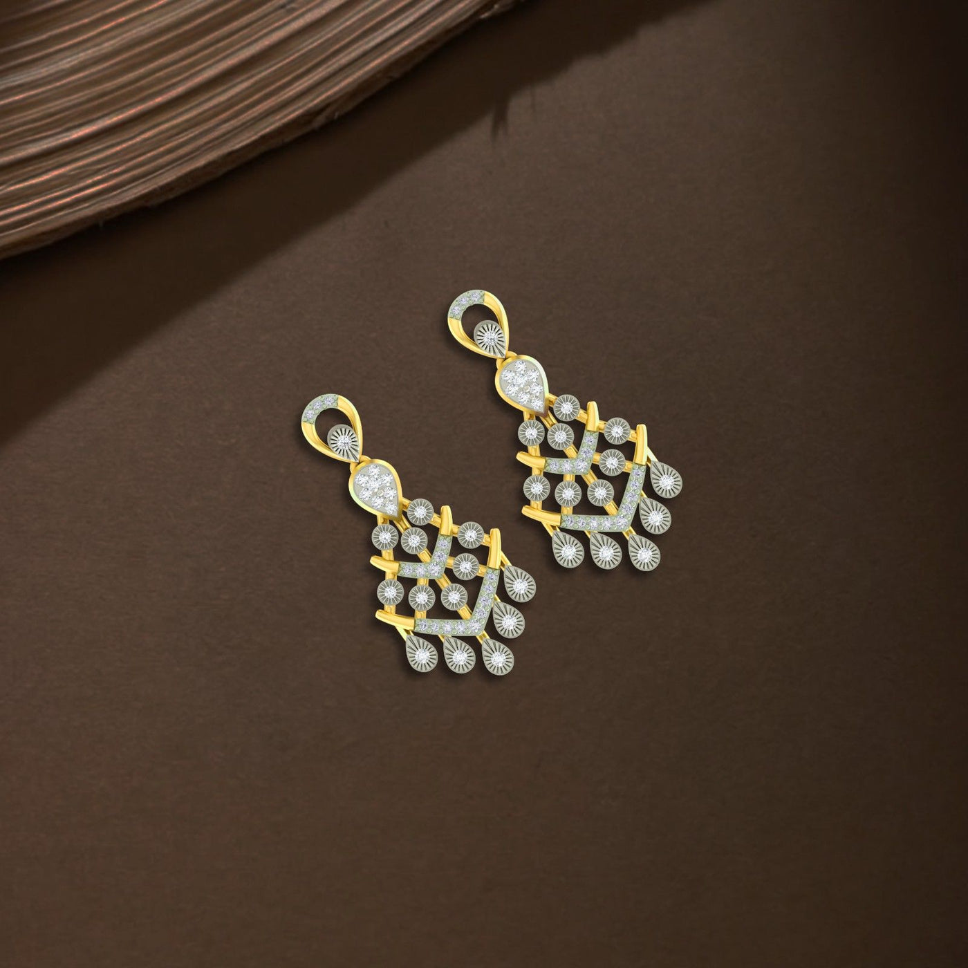 Gold and diamond chandelier earrings on a brown background