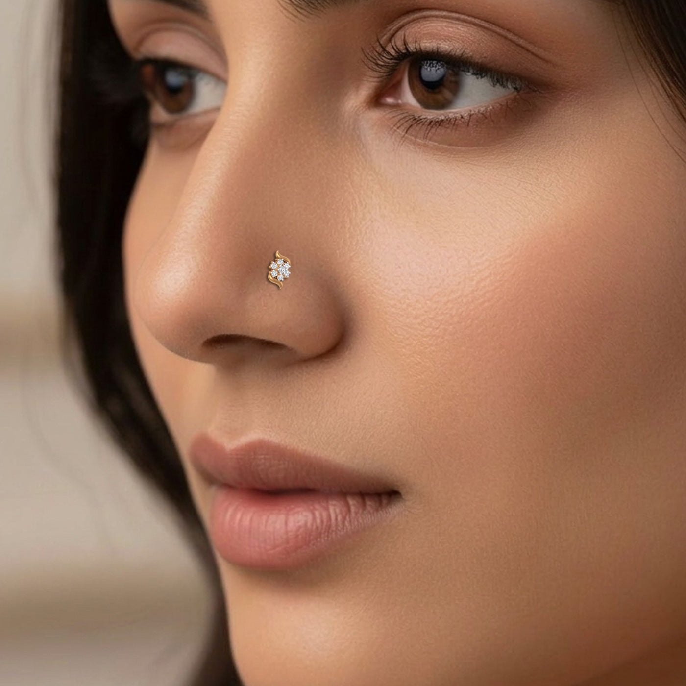 Close-up of a woman's face with a diamond nose pin.