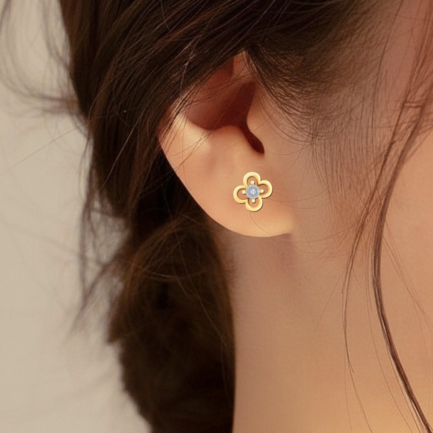 Gold and diamond floral stud earrings with, close-up shot.