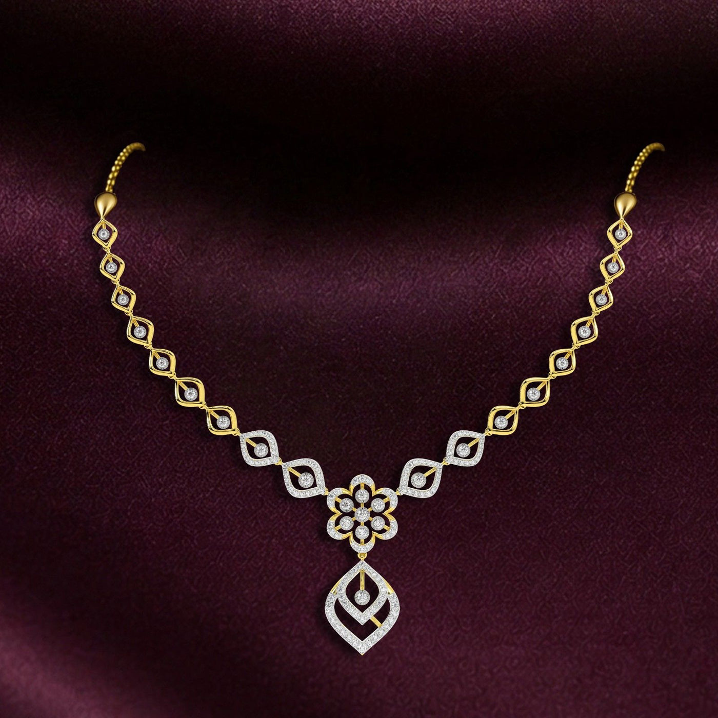 Gold and diamond necklace on a dark purple background