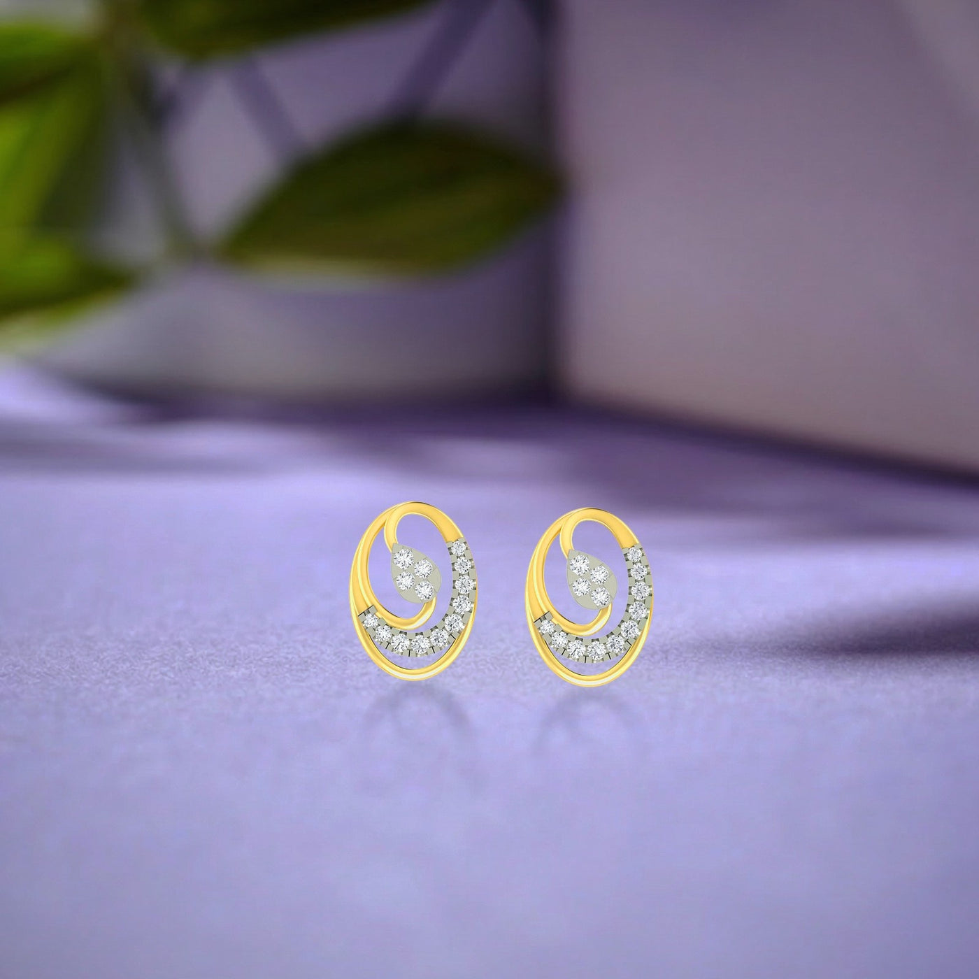 Gold and diamond stud earrings with round-shaped on a purple surface