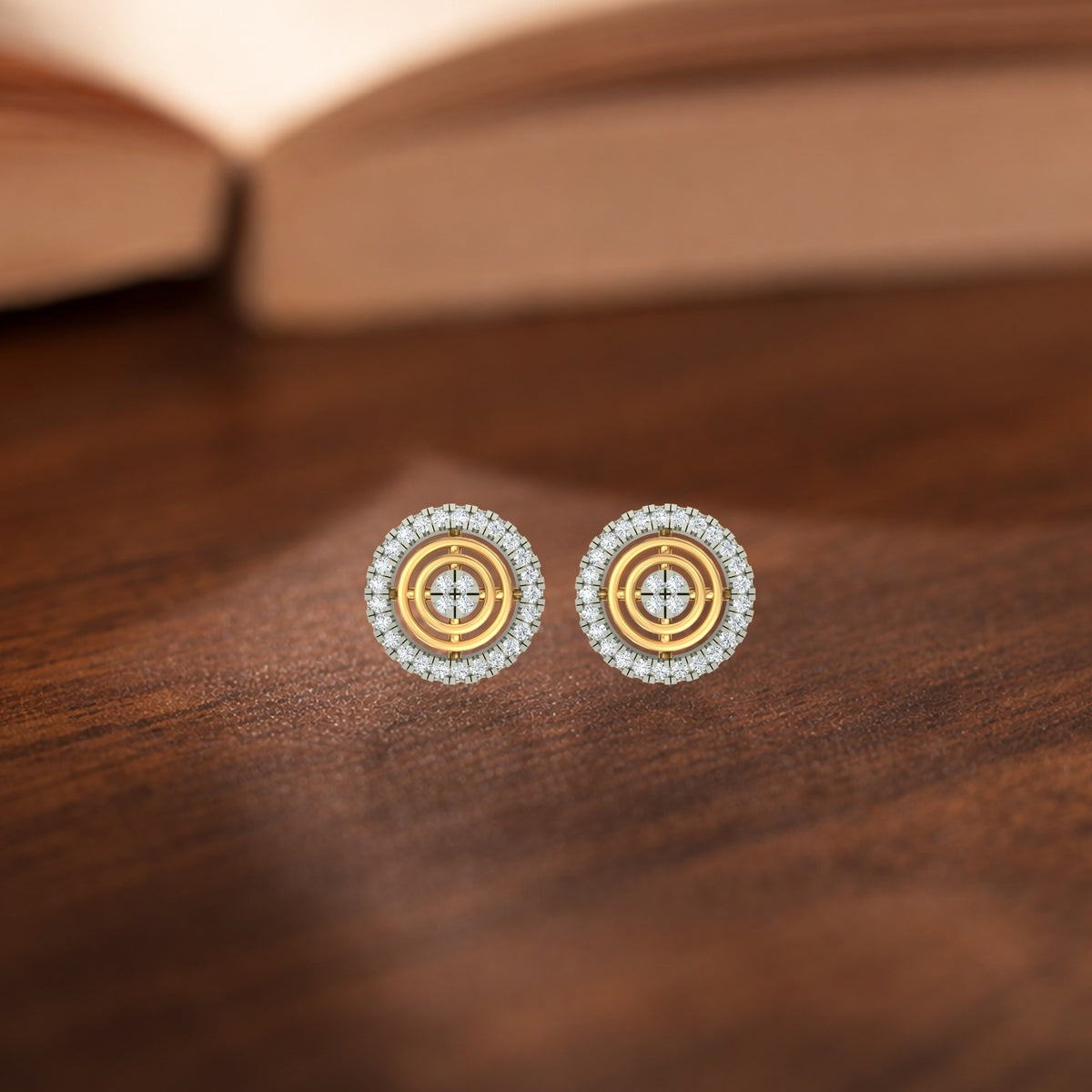 Gold earrings with diamond accents on a wooden surface