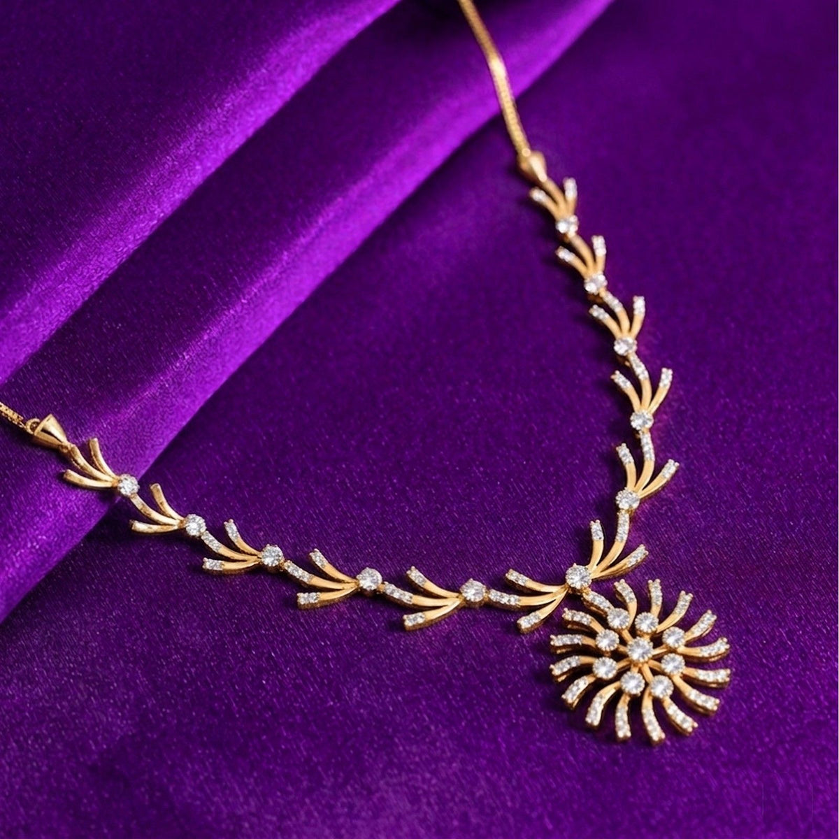 A gold and diamond necklace with a sunburst, displayed on a rich purple velvet fabric background.