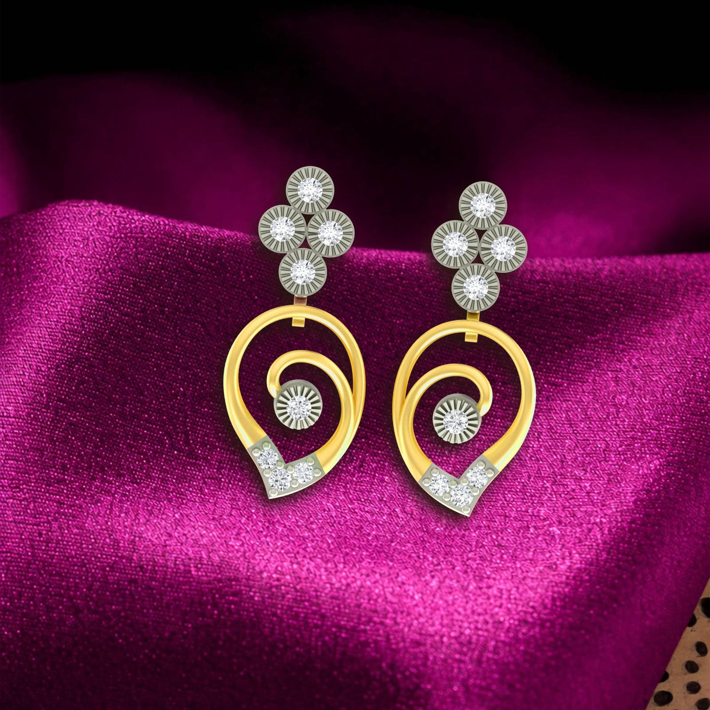 Gold and diamond drop earrings on a purple fabric background
