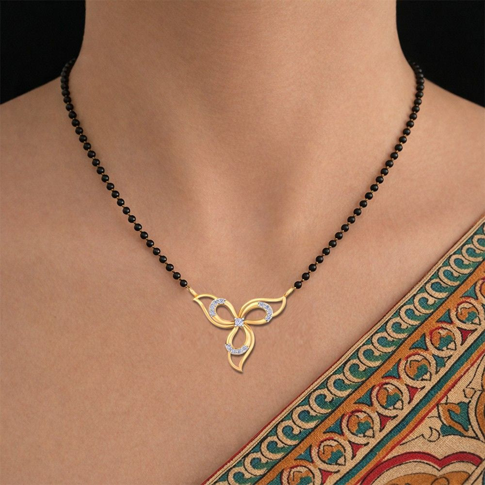 Women wearing gold and diamond butterfly mangalsutra on a black beaded 