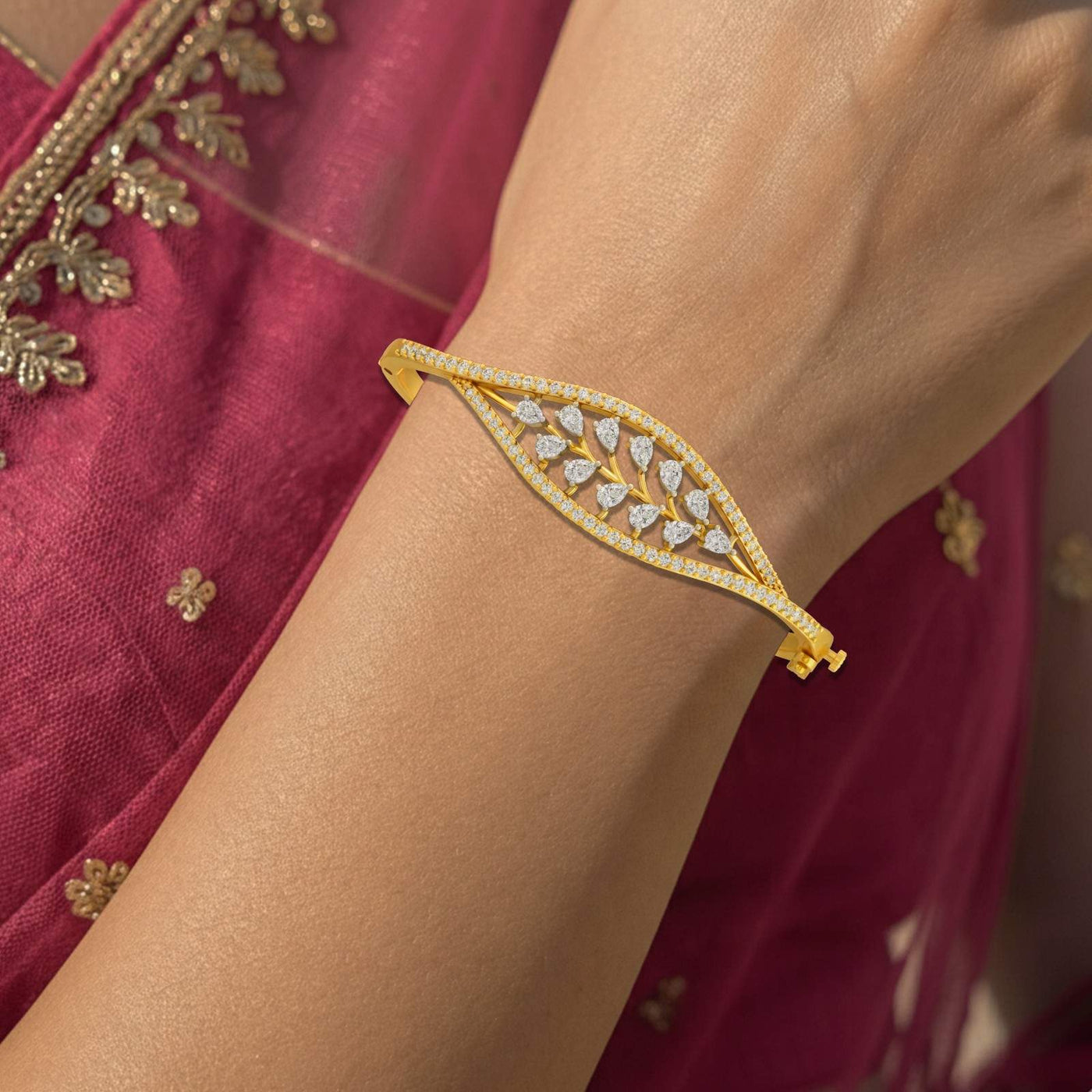 Elegant gold bangle bracelet with marquise diamond open-lattice design and pavé border.
