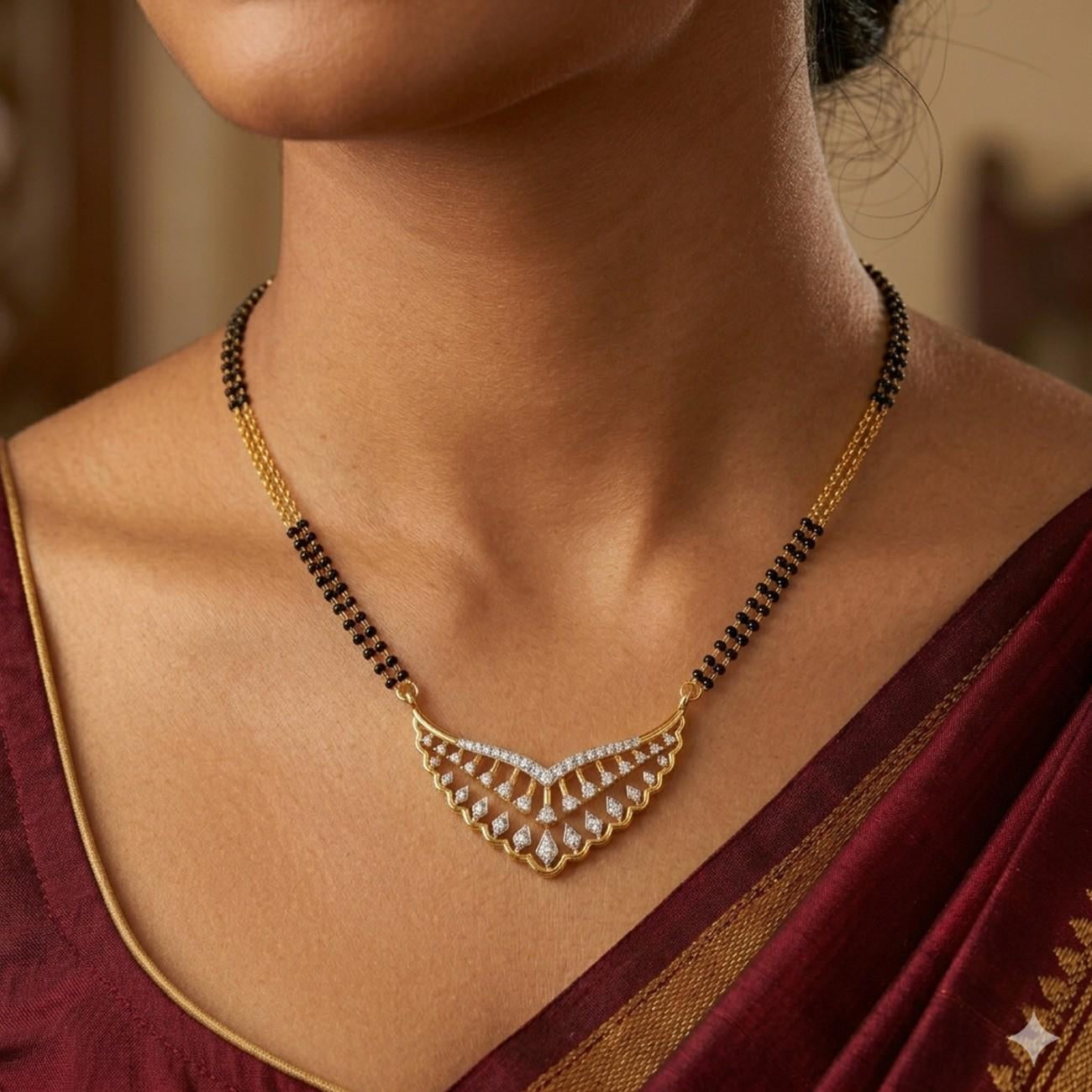 Women wearing gold & diamond floral mangalsutra on saree