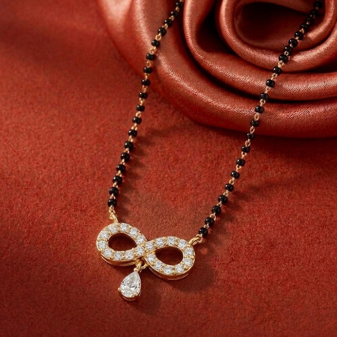 gold & diamond infinity mangalsutra on red background