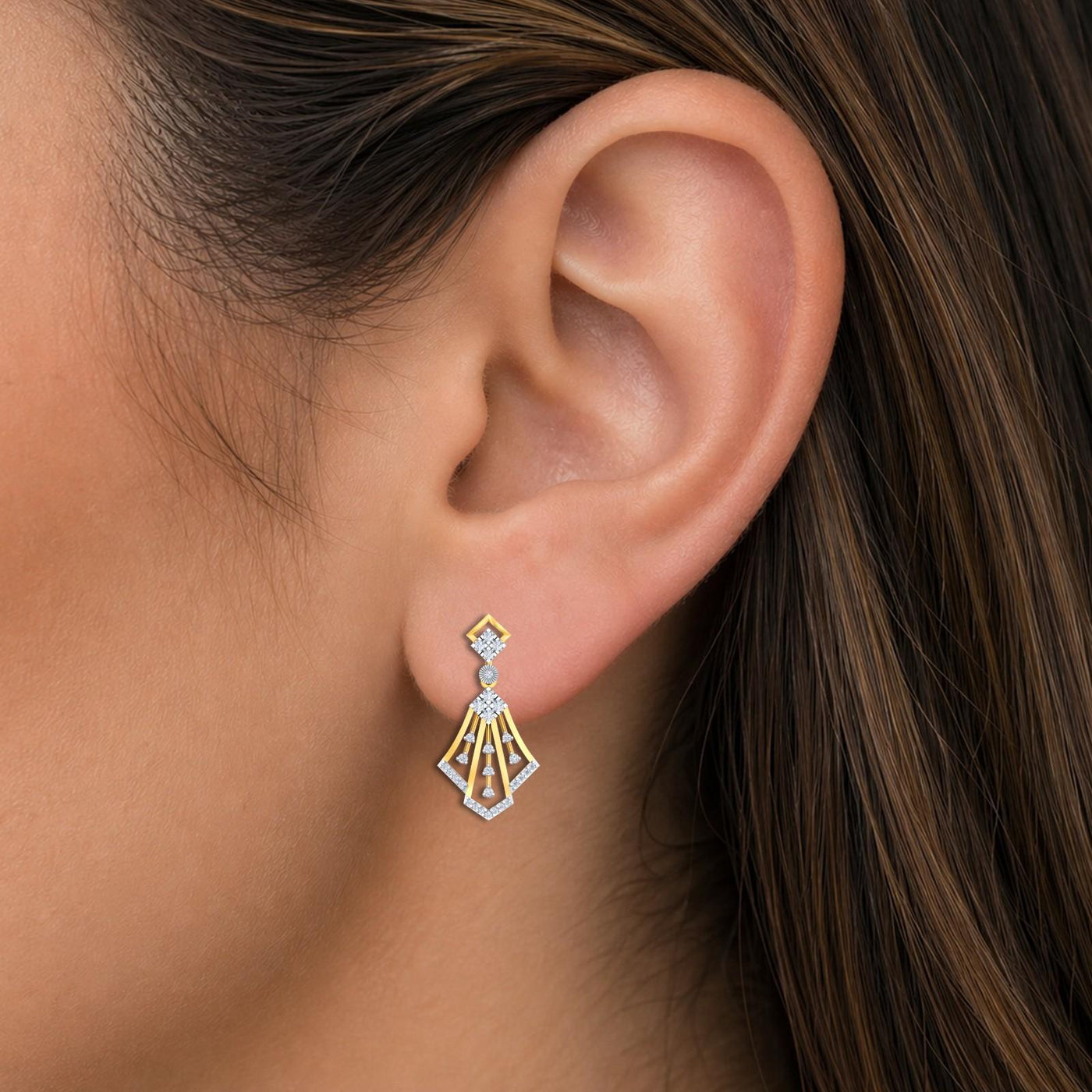 Close-up shot of a gold and diamond dangler earrings.