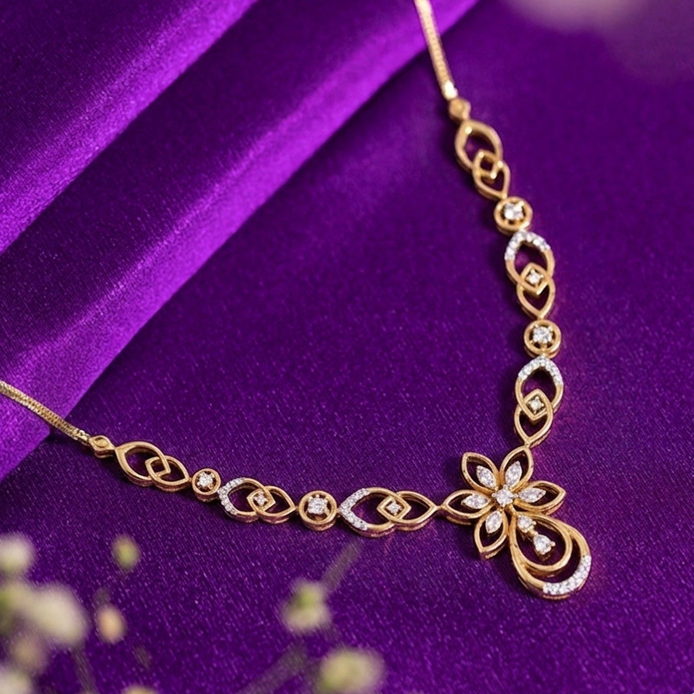 Gold and diamond necklace with floral design on a purple background.
