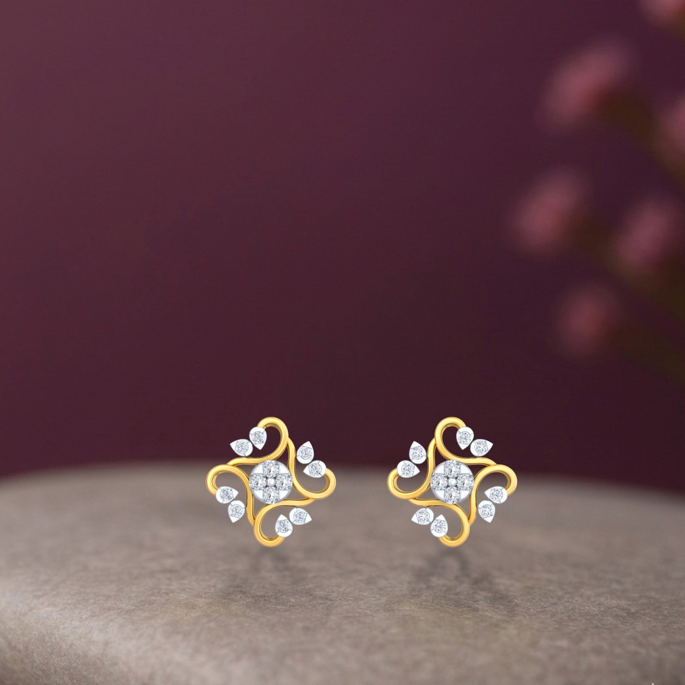 Gold and diamond floral stud earring on a beige background.