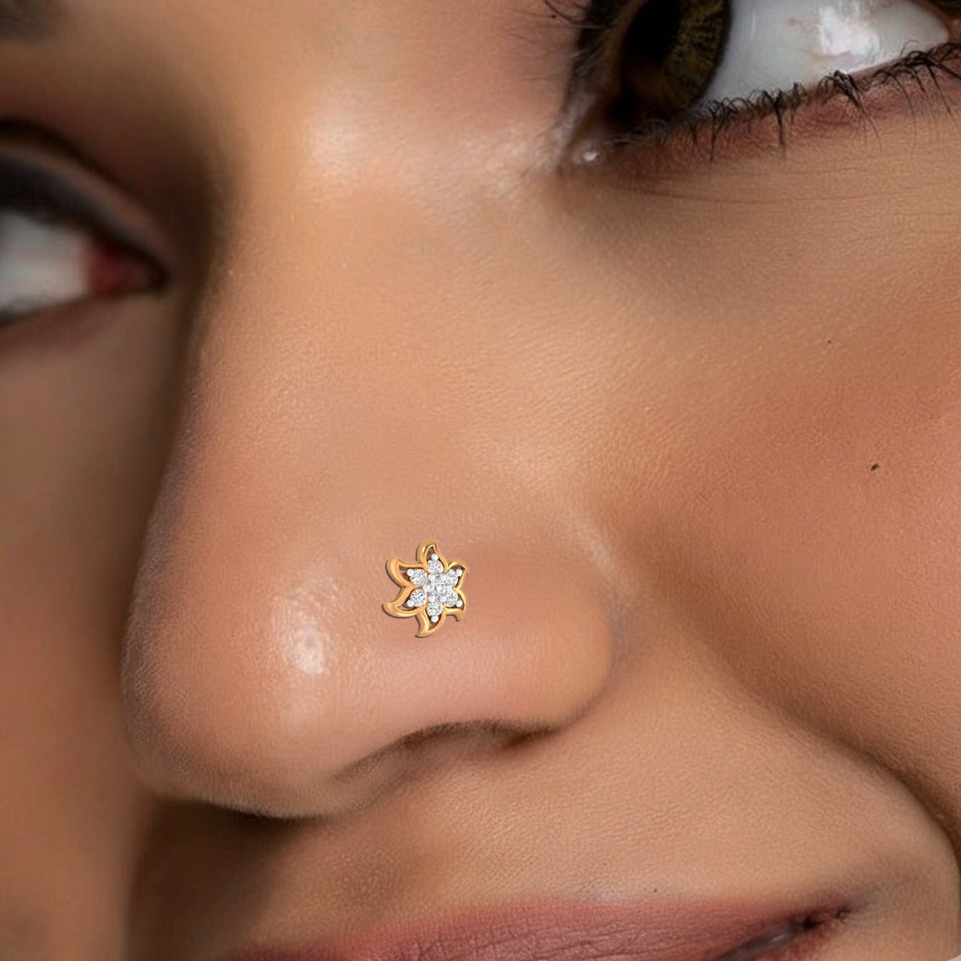Close-up of a person wearing a gold and diamond nose pin with a star design.