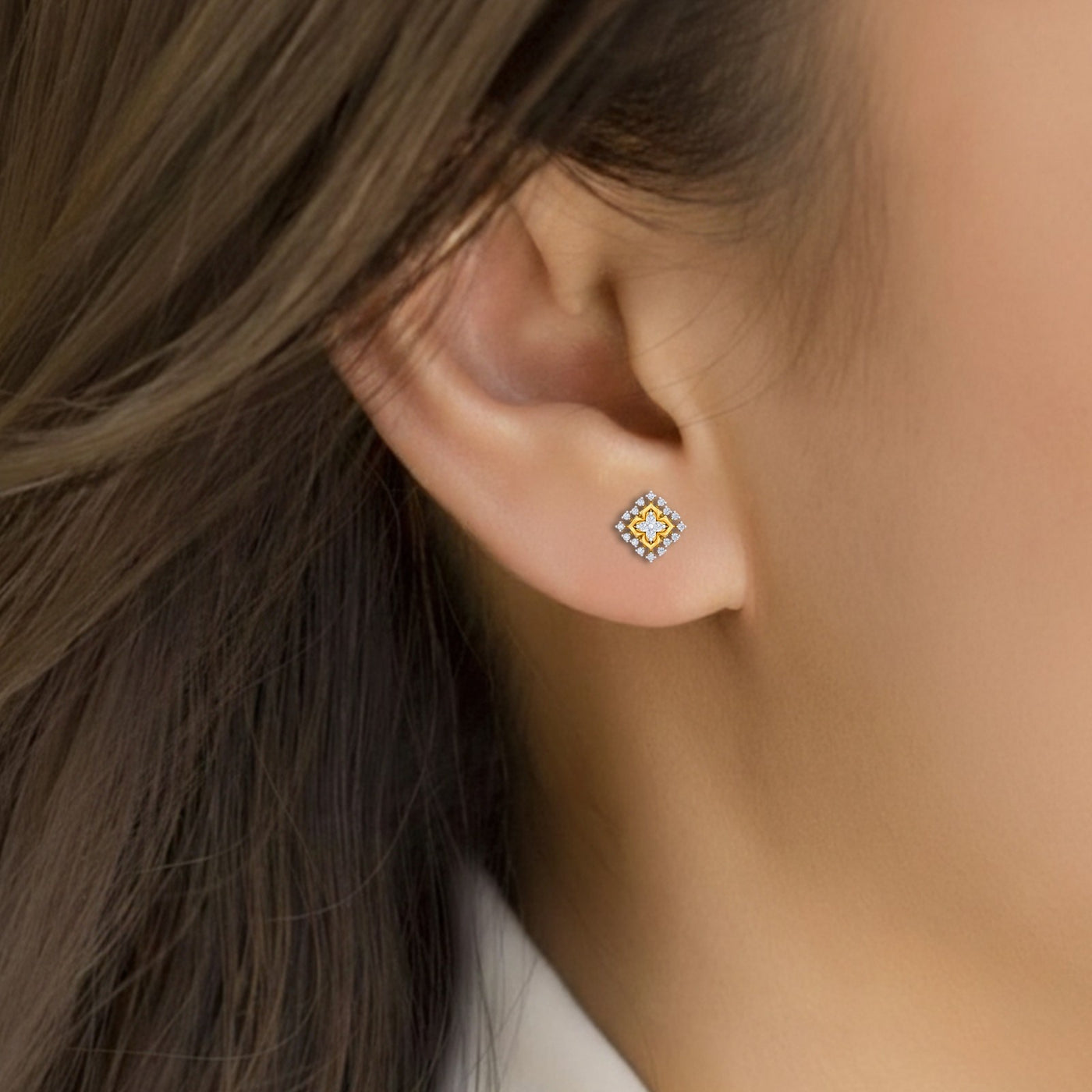 Close-up shot of a gold and diamond stud earrings.