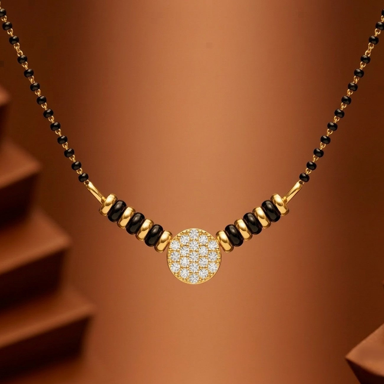 Yellow gold & diamond beaded mangalsutra on brownbackground