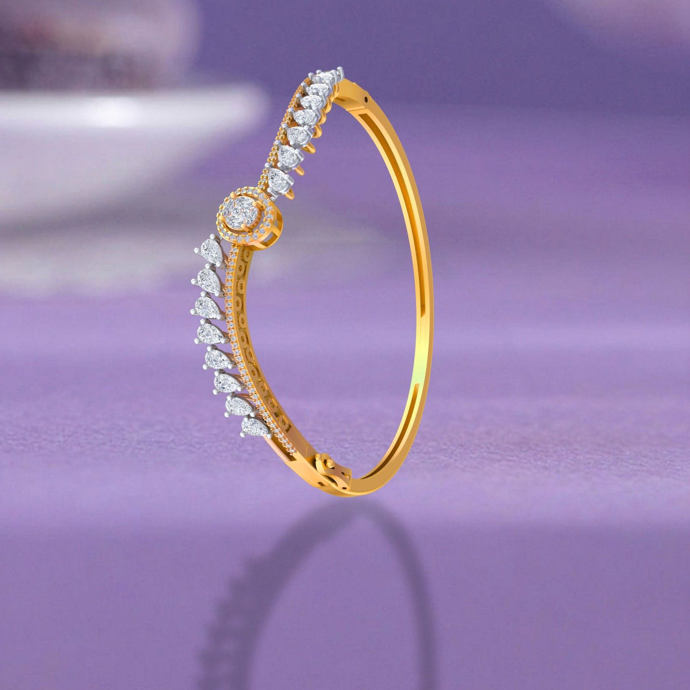 Yellow gold bangle bracelet with round halo diamond centerpiece and pear-cut diamond accents.